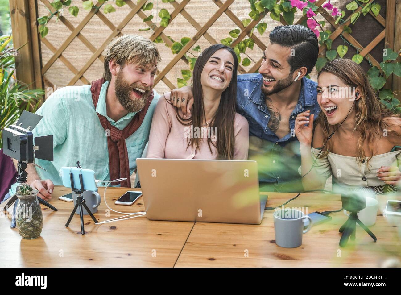 Young people streaming online using laptop and phone camera Millennial friends having fun with new technology trend Social media vlogging concept Stock Photo Alamy