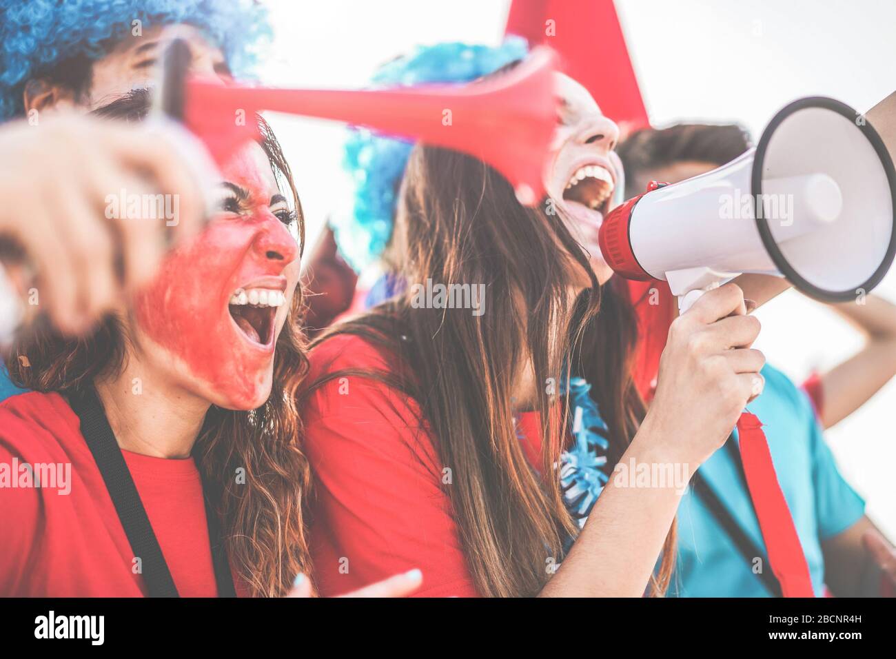 Crazy sport fans screaming while supporting their team Football