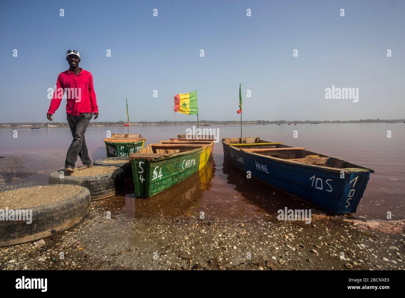 Man on a boat by Lake Retba (Pink Lake) in Senegal Stock Photo