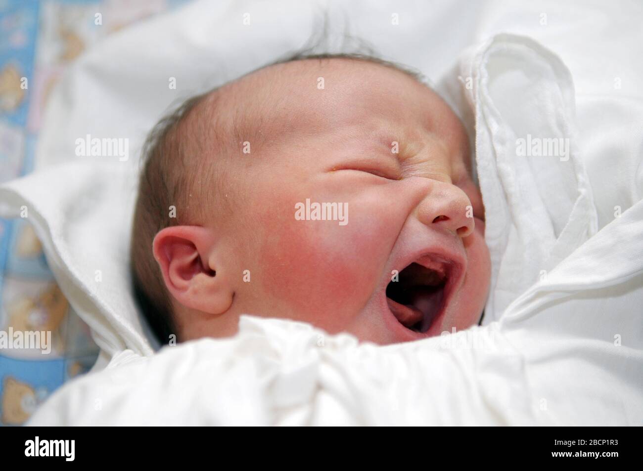 Baby in white swaddling clothes Stock Photo Alamy