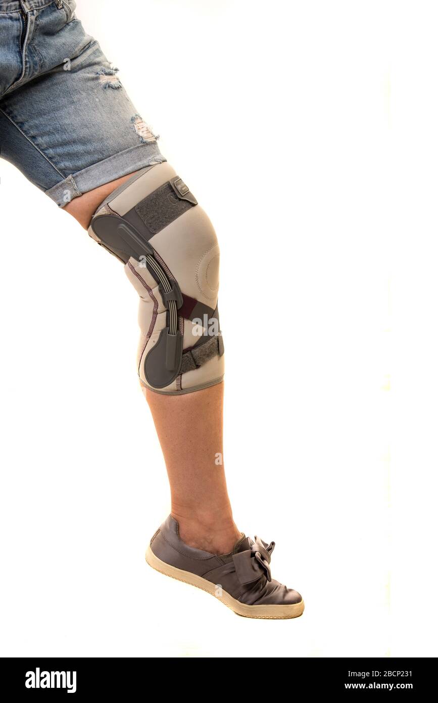 Woman After Car Accident In An Orthosis Sitting On Couch. Female Fastening  Knee Orthosis Or Knee Support Brace After Surgery On Leg Stock Photo,  Picture and Royalty Free Image. Image 194338779.