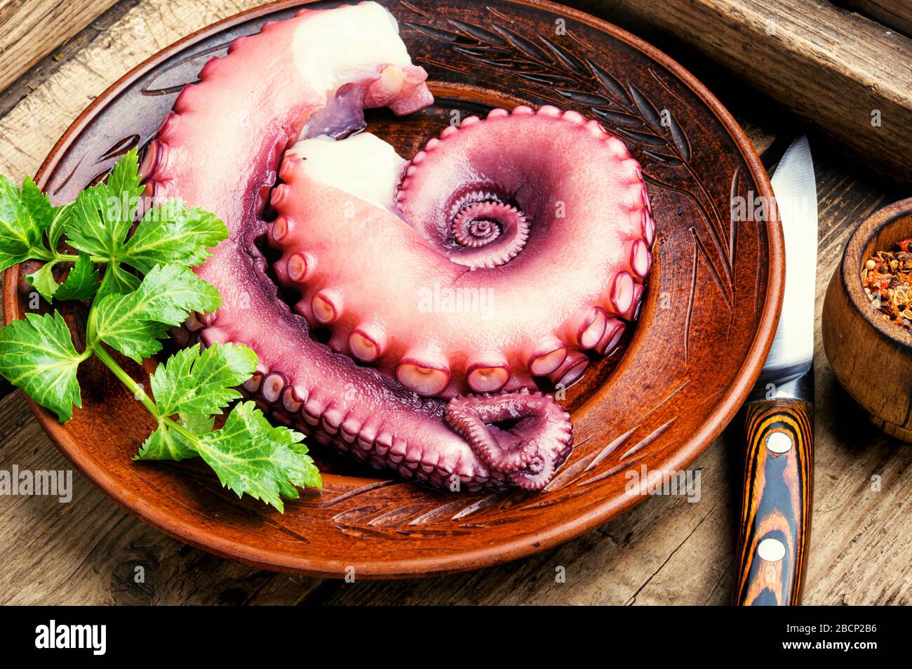Raw uncooked octopus and a set of spices for cooking Stock Photo Alamy