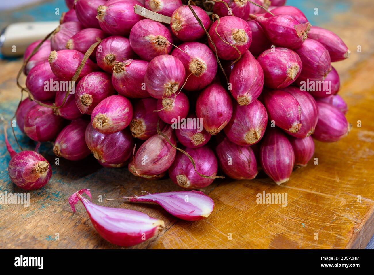 Bunch of high quality small red shallot sambar onions from India Stock Photo