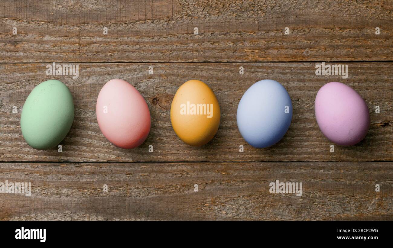 Five colored easter eggs on wooden boards Stock Photo