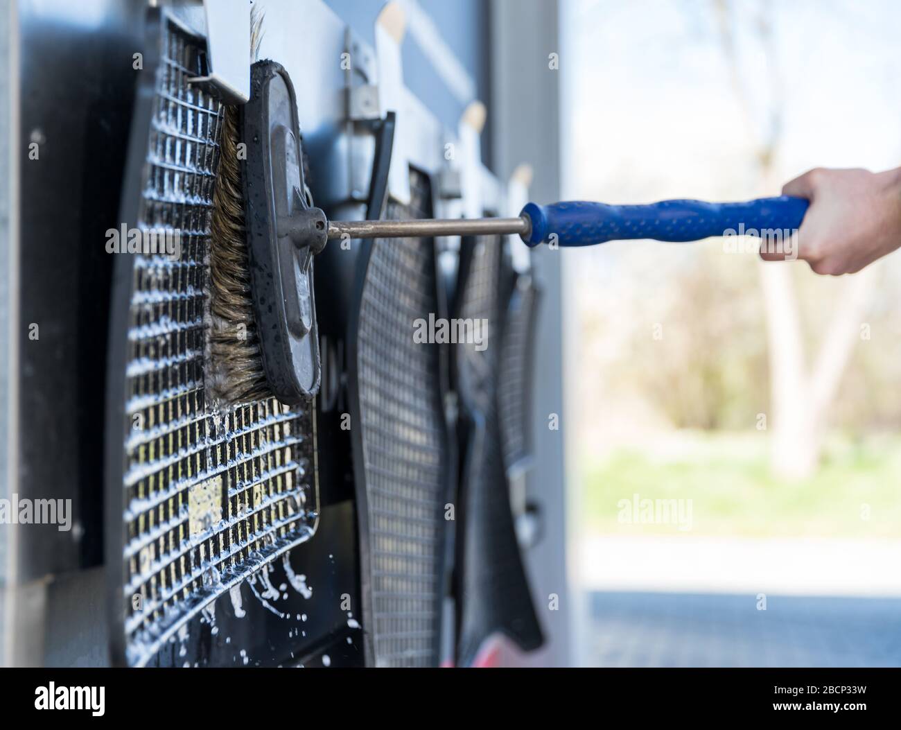 Hand wash rubber rugs from the car using a brush with foam Stock Photo