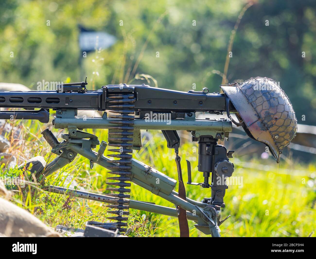 Reviving history of Slovenia Pivka museum of military history representing WW2 German Army equipment machine gun MG42 with steel helmet attached Stock Photo