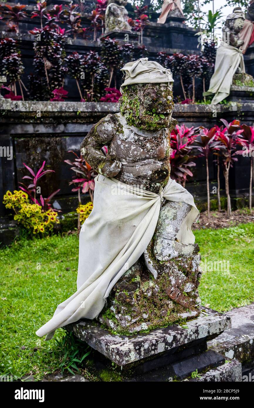 A sculpture of a mythological creature dressed in sarong and udeng in Pura Besakih Temple, Bali, Indonesia Stock Photo