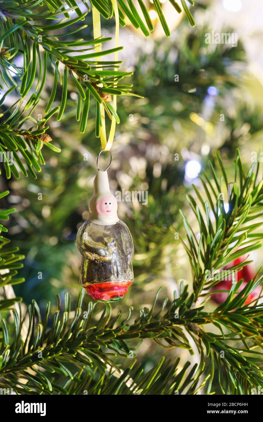 Glass village Baba-new years Soviet Christmas tree toy hanging on a branch of green fir Stock Photo