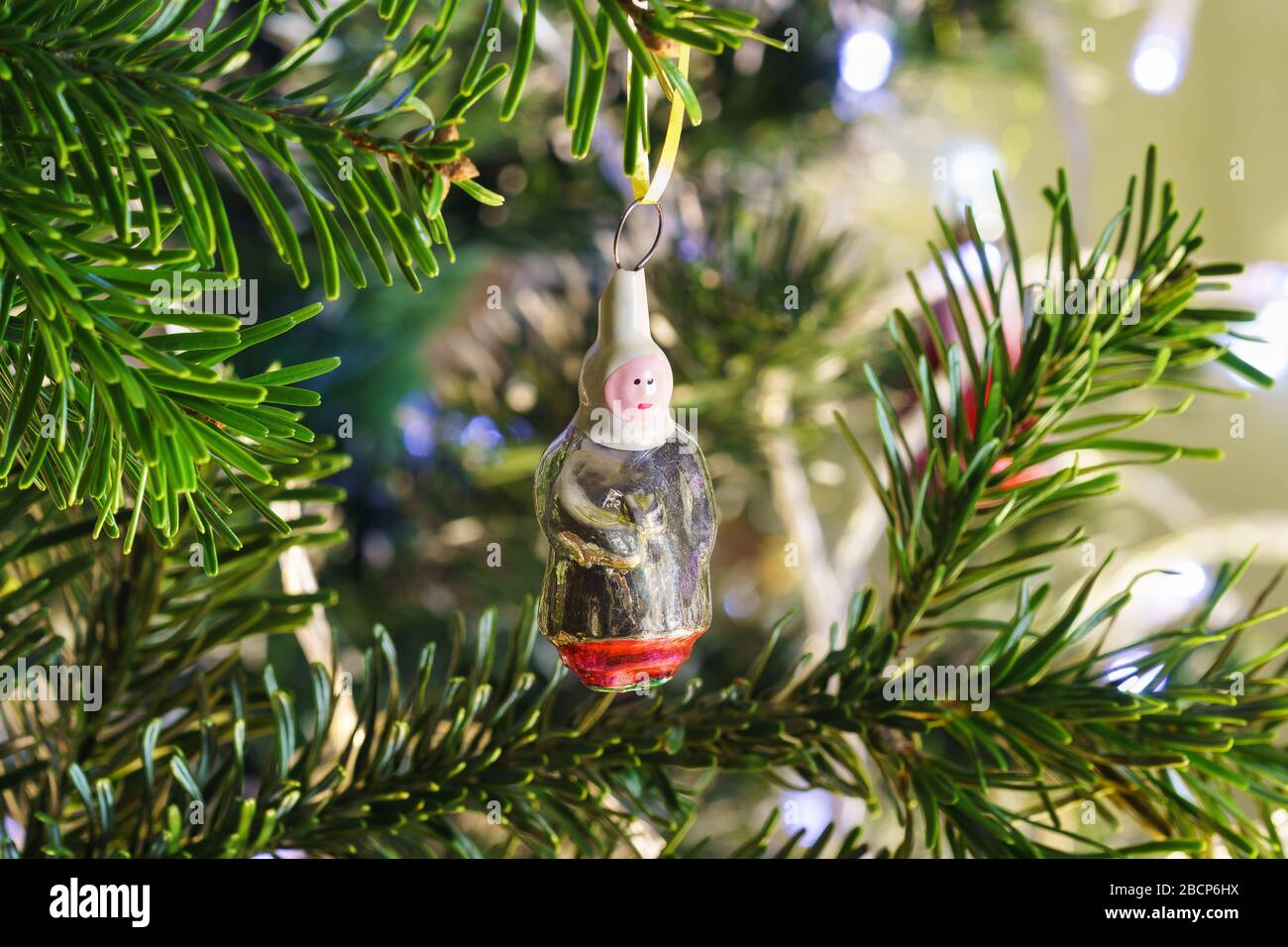 Glass village woman-new years Soviet Christmas tree toy hanging on a branch of green fir Stock Photo