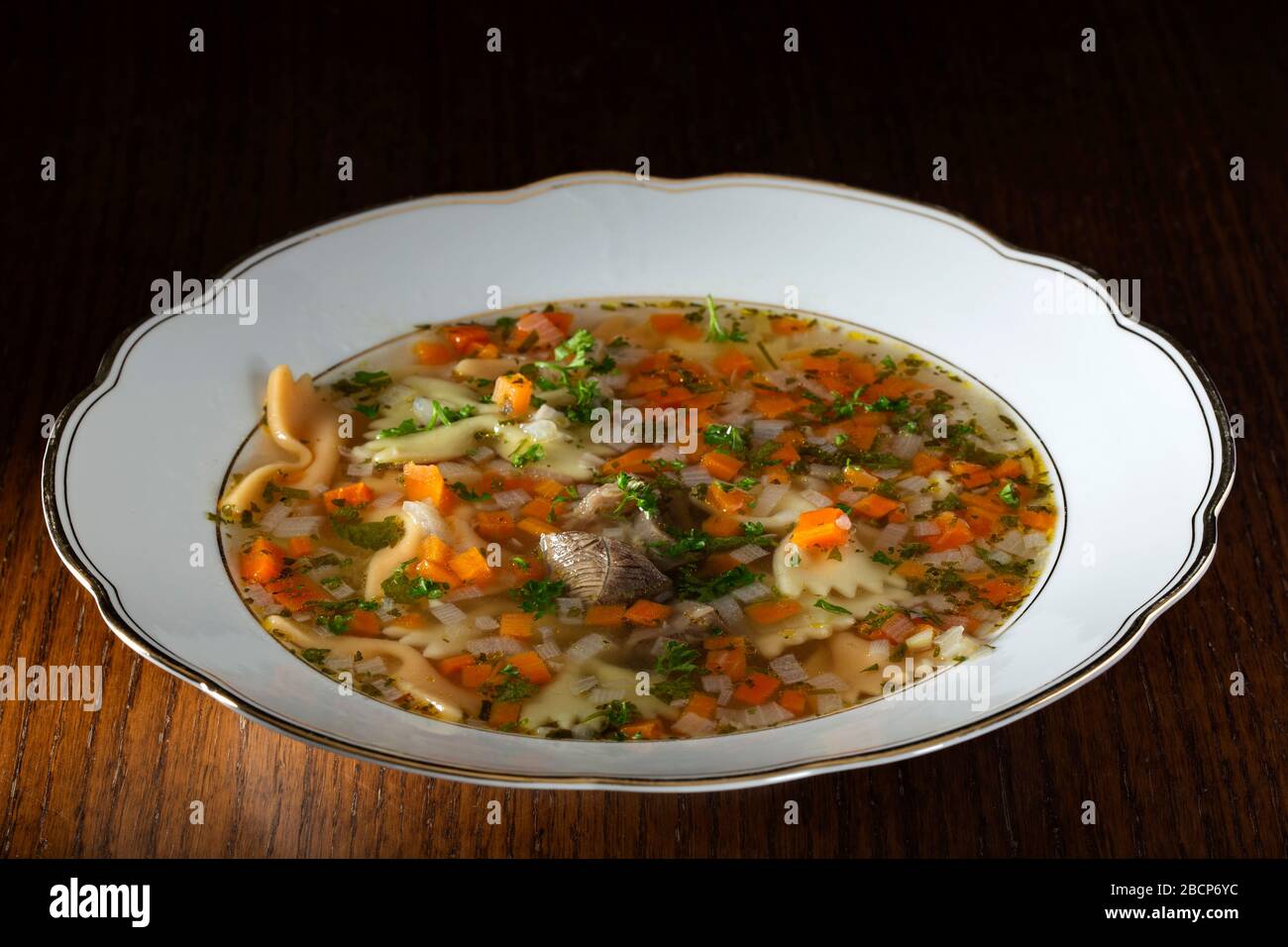 Beef soup with vegetables and fresh chopped parsley Stock Photo