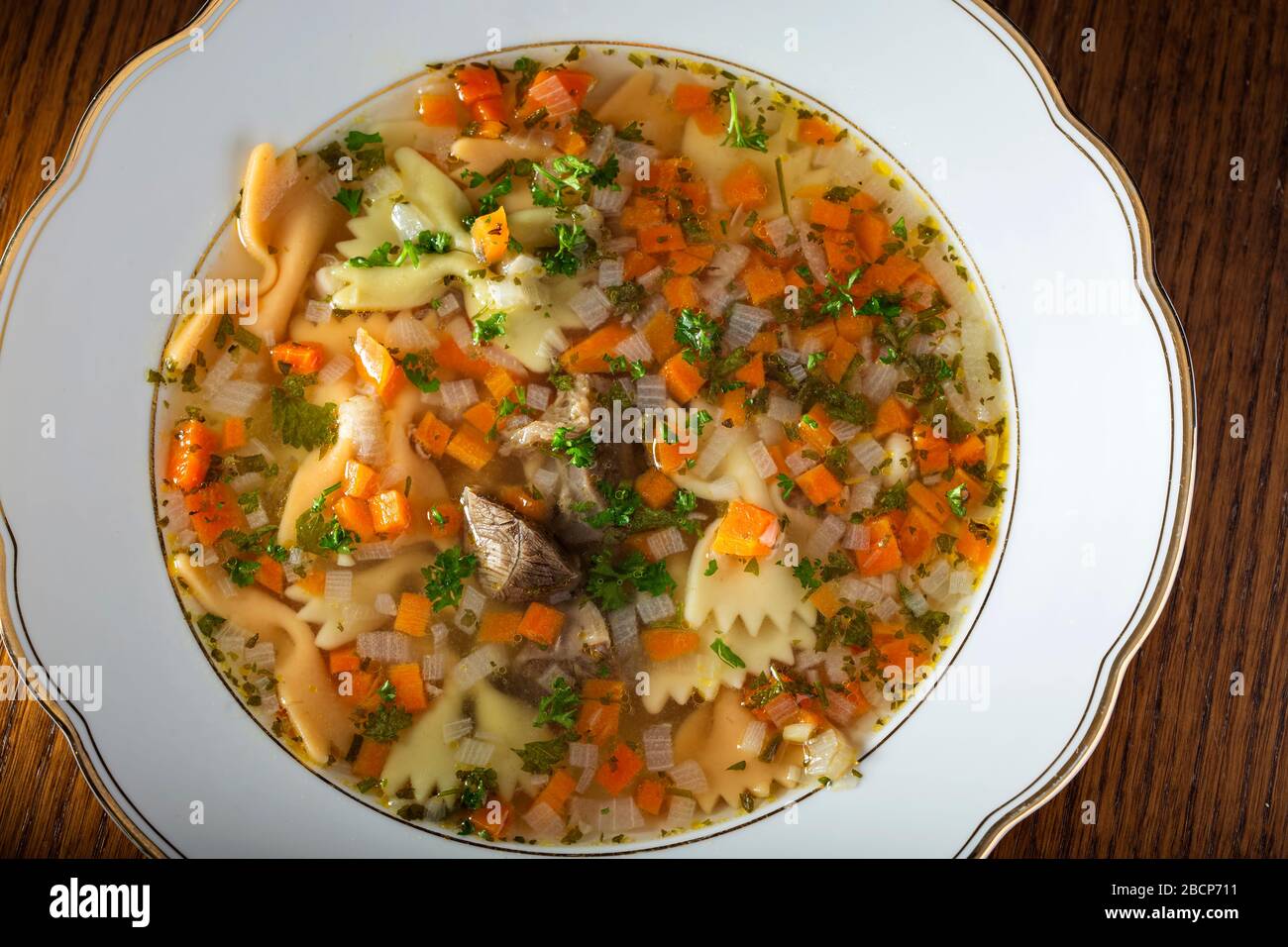 Beef soup with vegetables and fresh chopped parsley - top view Stock Photo