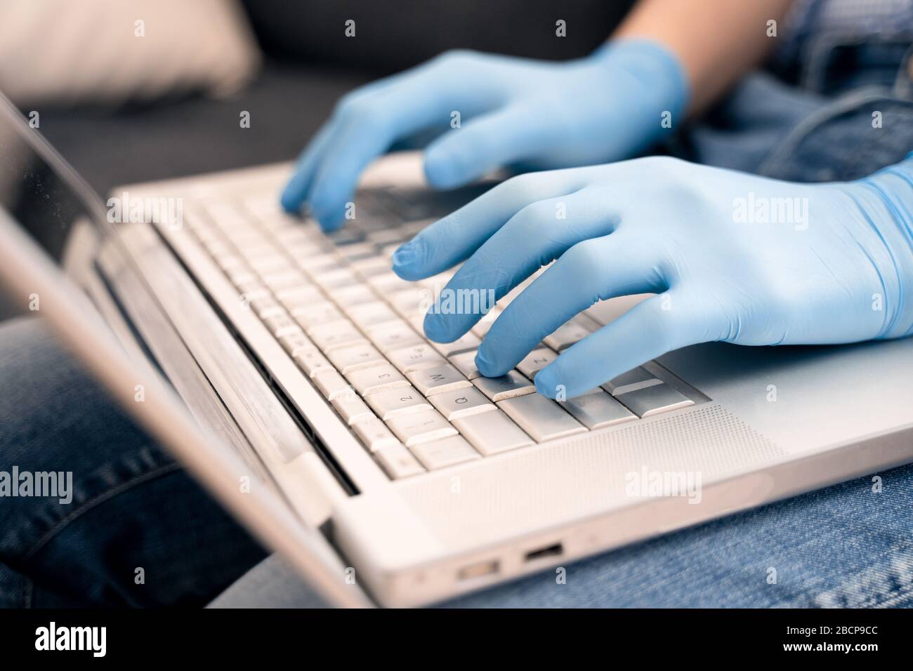 Working on computer using safety precautions Stock Photo Alamy