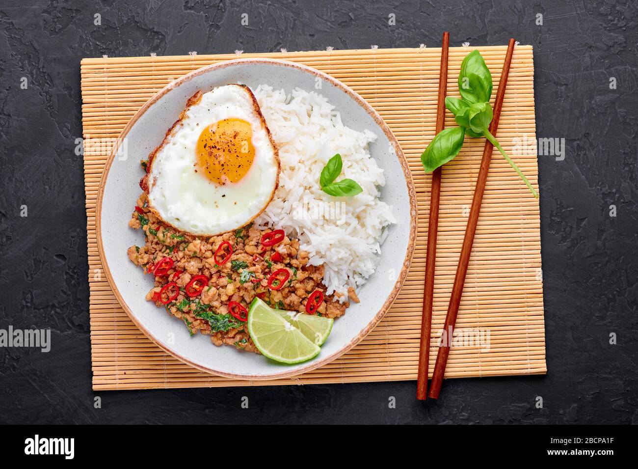 Pad Krapow Gai Thai Basil Chicken with Rice and fried Egg black slate