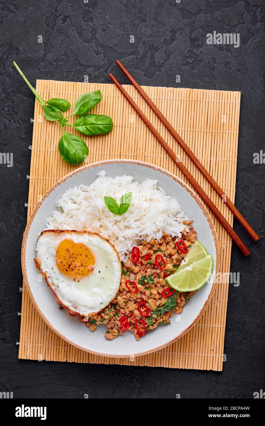 Pad Krapow Gai Thai Basil Chicken with Rice and fried Egg black slate