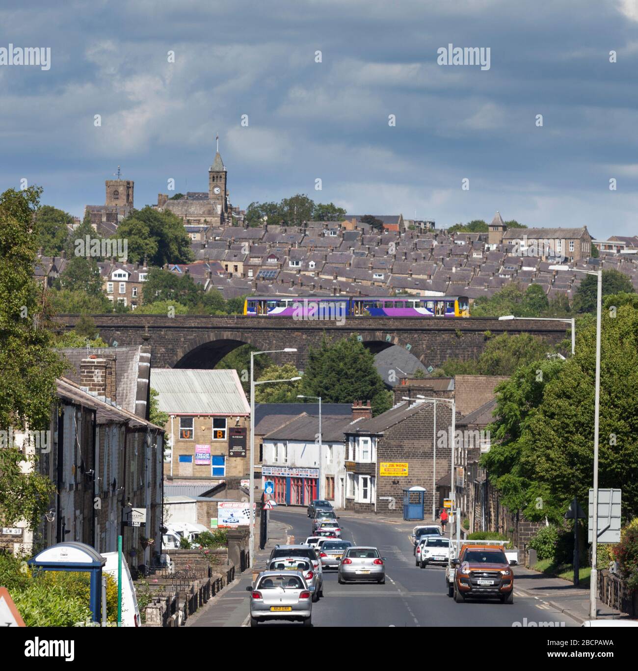 Northern Rail / Northern Trains class 142 pacer train crossing Cole viaduct seen looking down Burnley road, the main street. Stock Photo