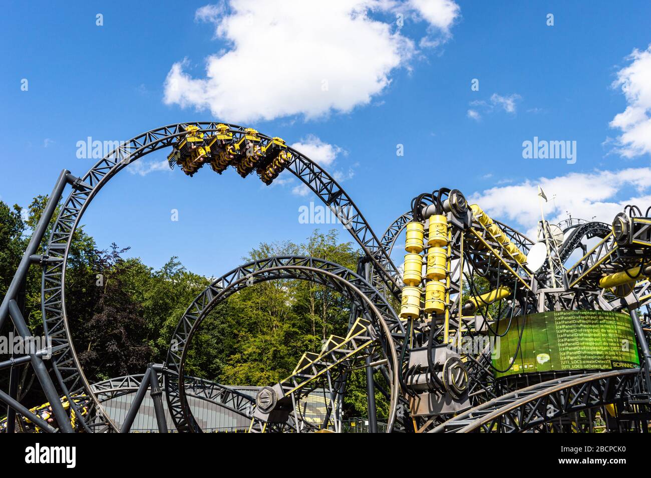 The Smiler at Alton Towers Theme park, UK. Yellow cars fly round the track which has world record 14 inversions. 3 minutes long with a vertical lift Stock Photo