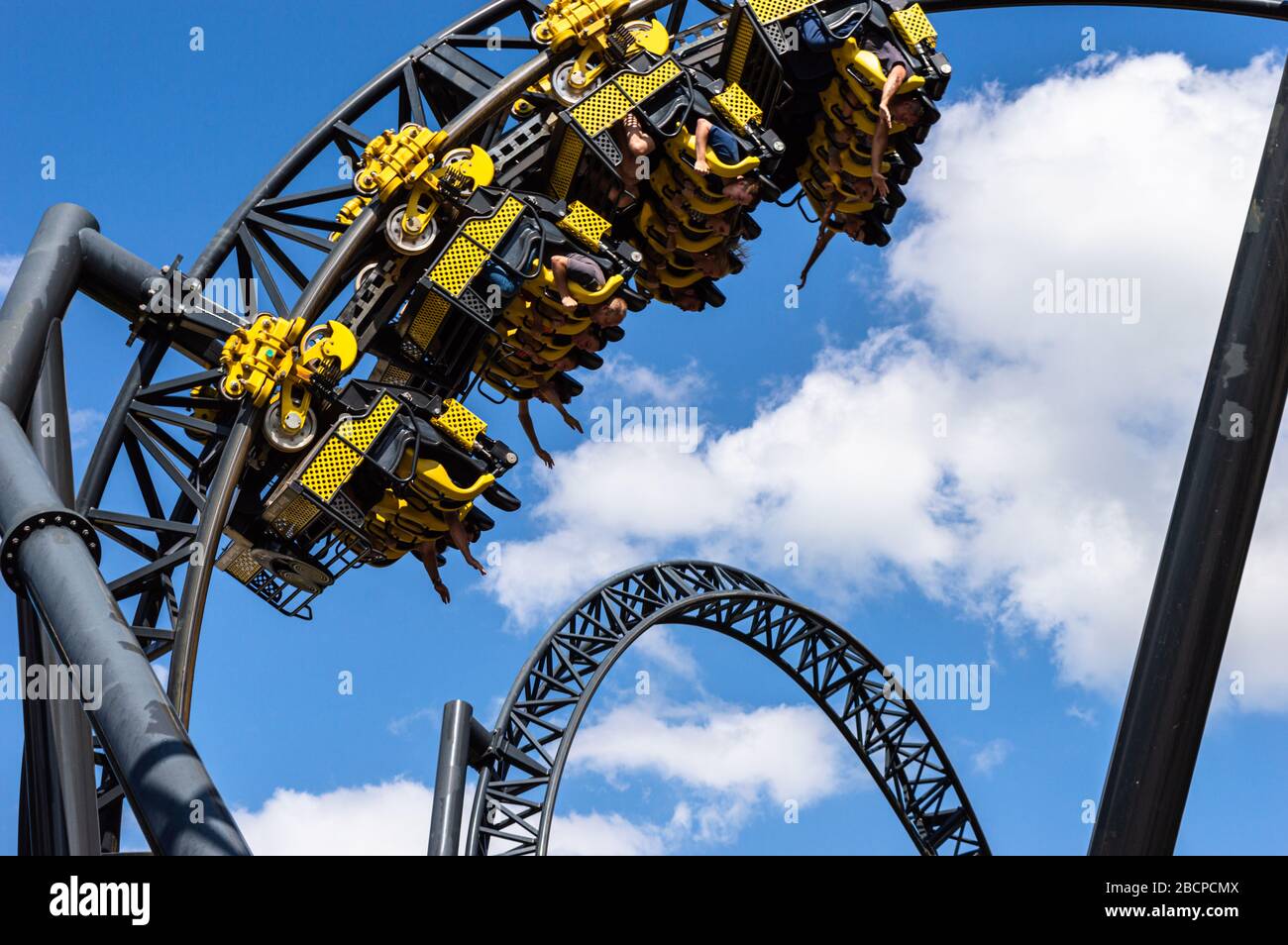 The Smiler at Alton Towers Theme park, UK. Yellow cars fly round the track which has world record 14 inversions. 3 minutes long with a vertical lift Stock Photo