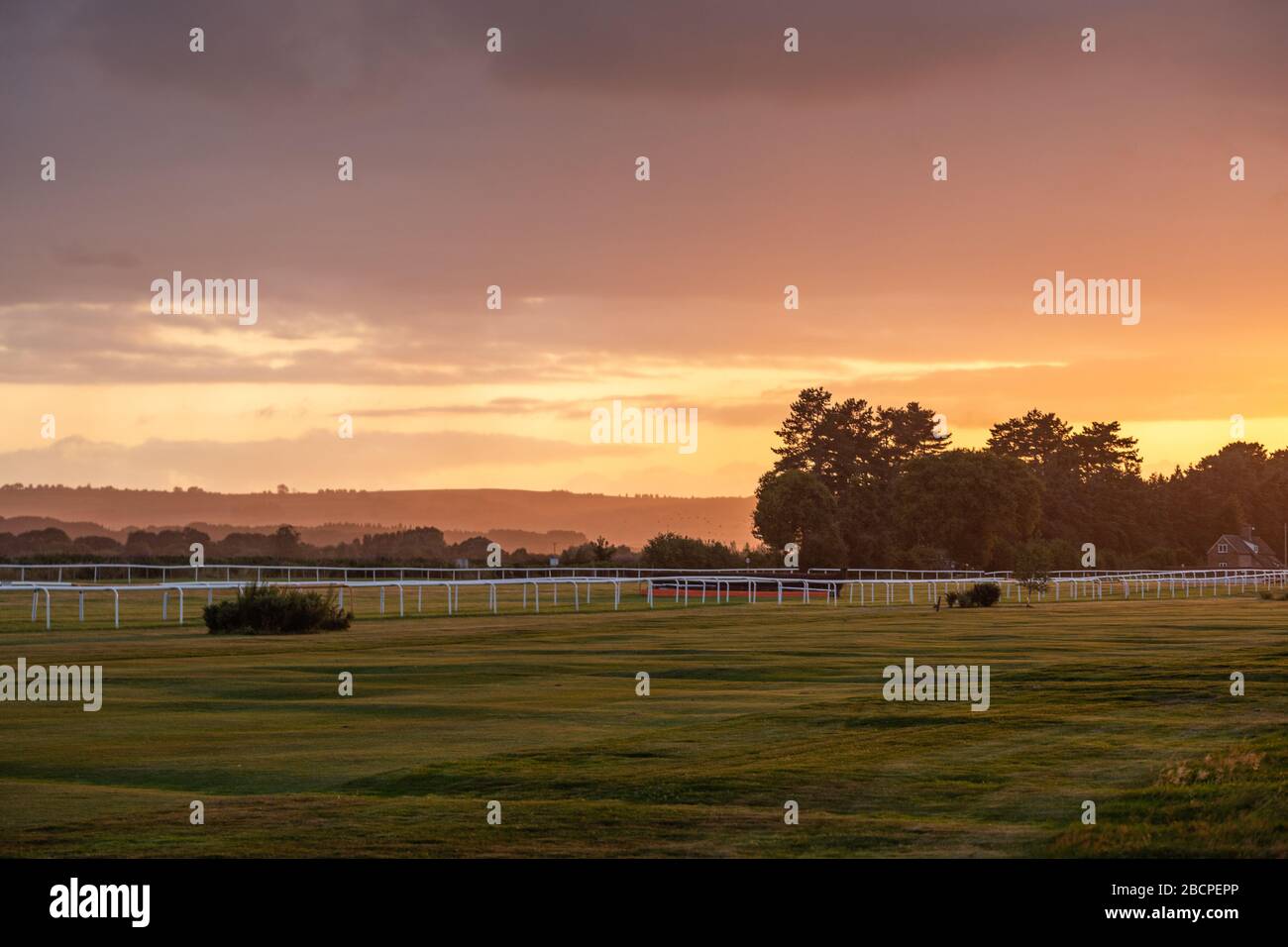 Stormy sunset sky over horse race track in United Kingdom Stock Photo