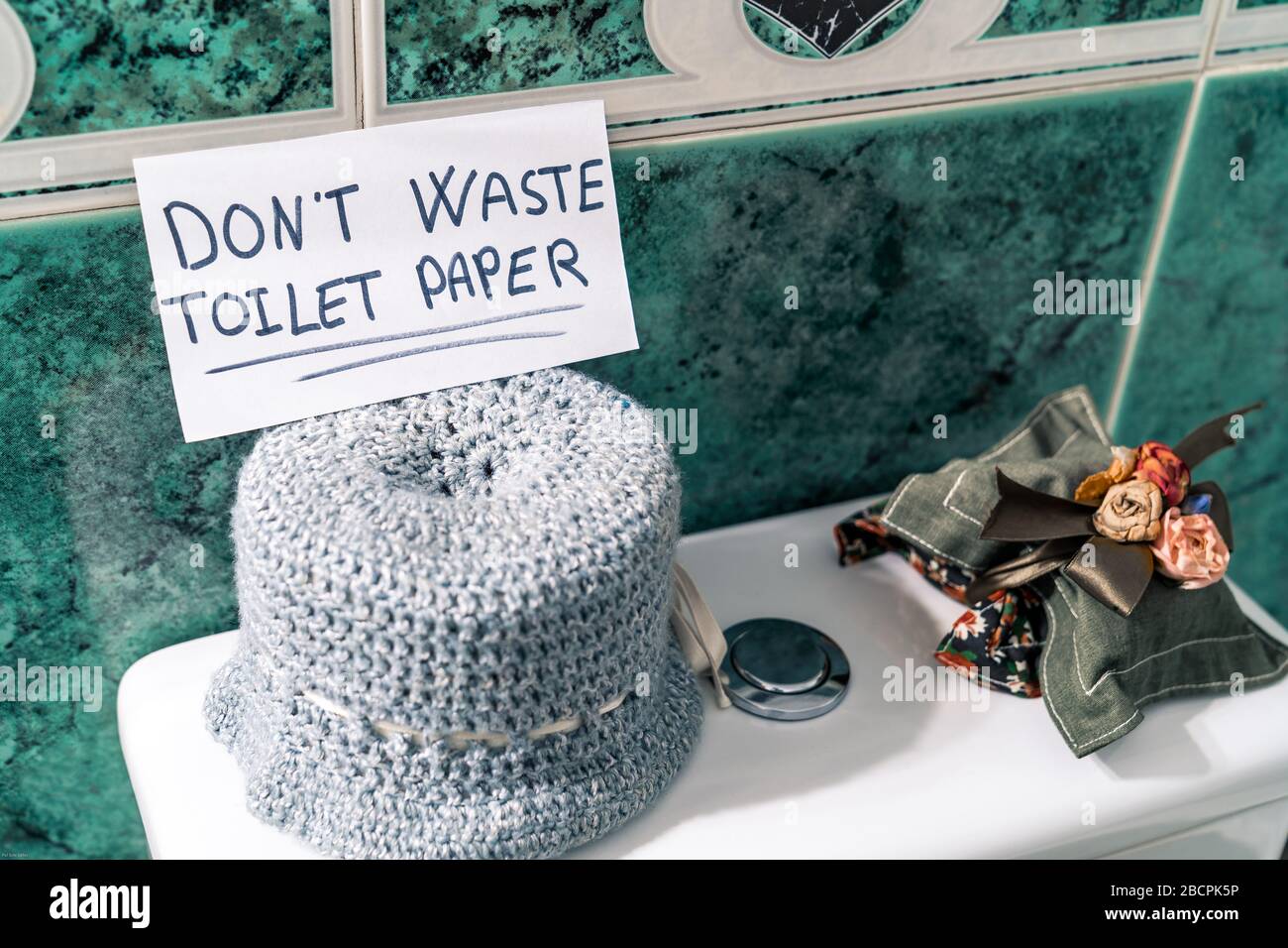 Don't waste the toilet paper. Message written on a toilet paper due to coronavirus crisis. Stock Photo