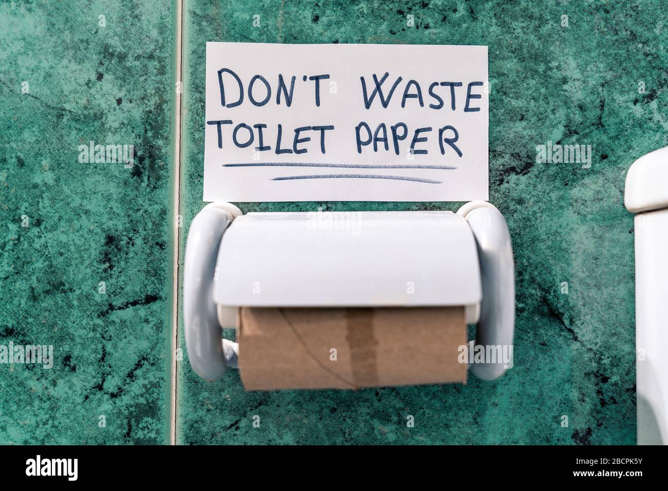 Finished roll of toilet paper in the bathroom. Don't waste the toilet paper that's written on