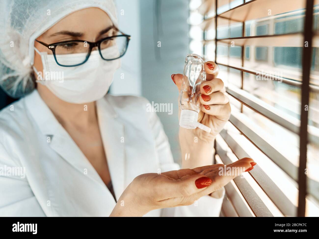 Portrait of a nurse using an antibacterial gel Stock Photo Alamy