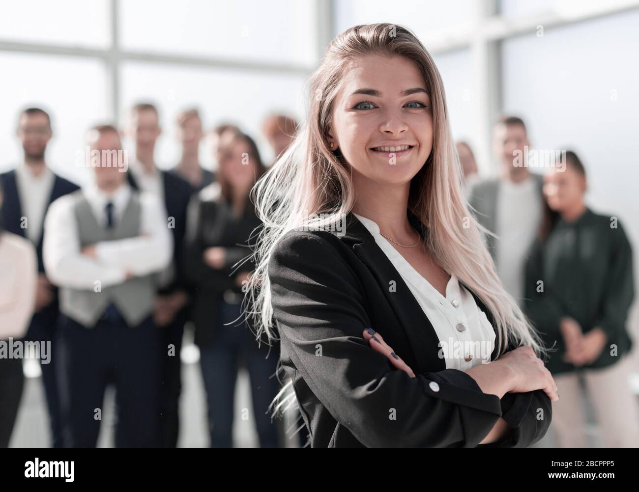 successful business woman on the background of a group of young employees Stock Photo - Alamy