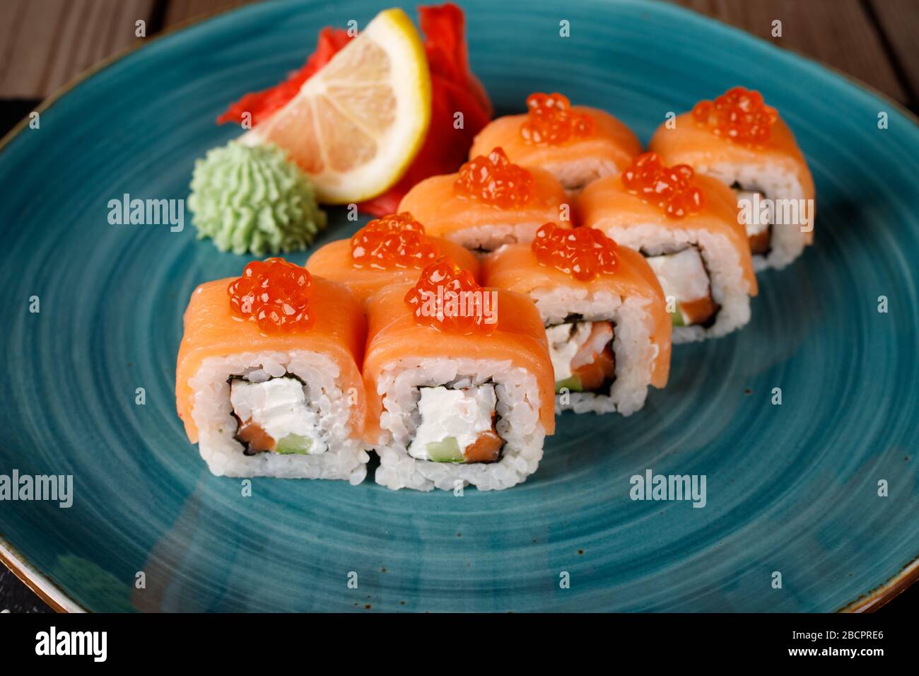 Rolls, wasabi, soy sauce, ginger on the table, avocado. The view from the top. Stock Photo