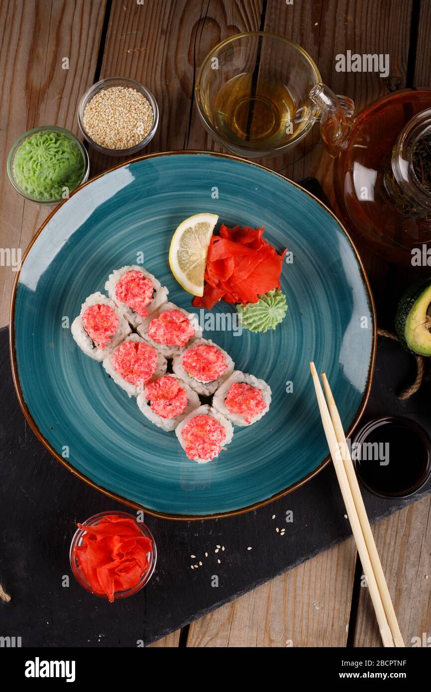 Rolls, wasabi, soy sauce, ginger on the table, avocado. The view from the top. Stock Photo
