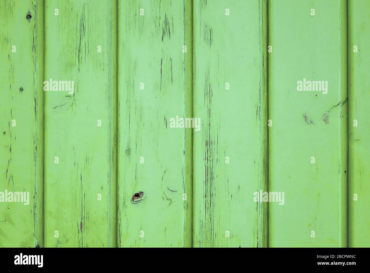 Wooden background of aged vertical planks, cheerful apple green color. Vintage Summer / Spring background. Stock Photo