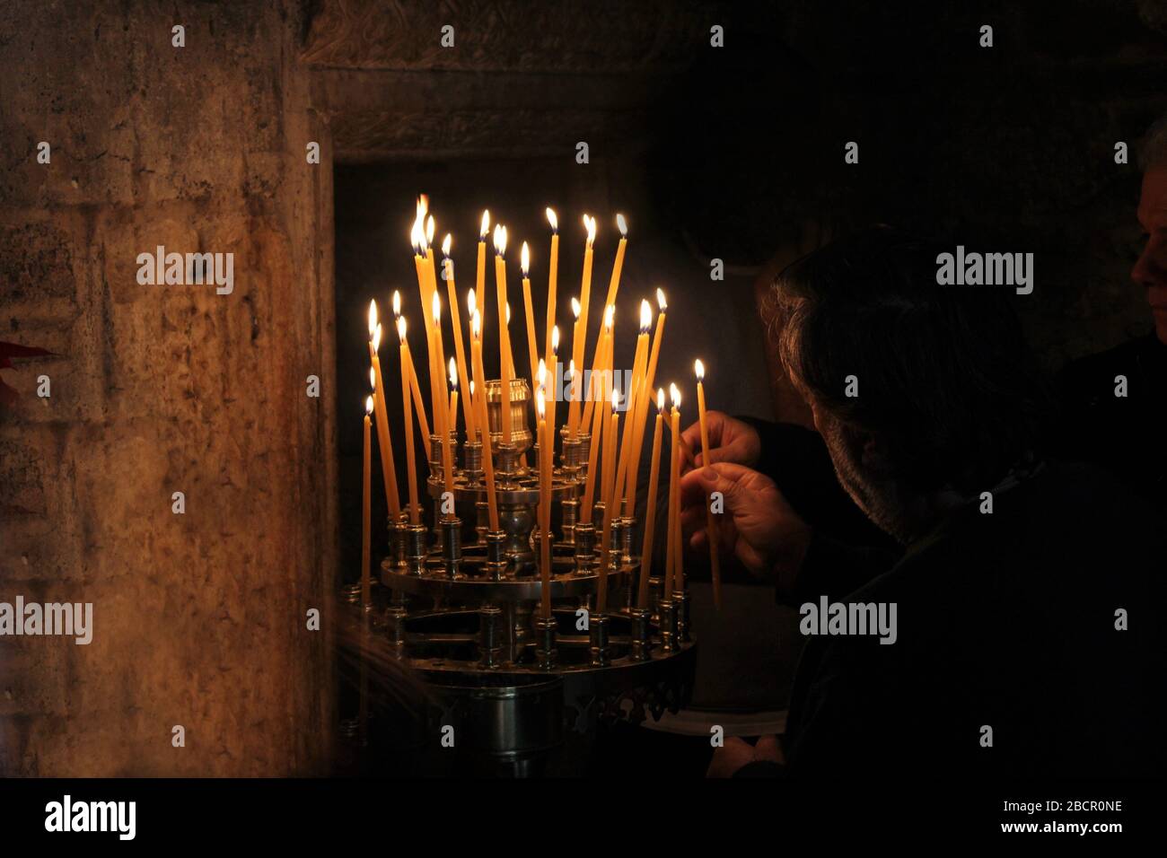 Lighting candles inside a Greek orthodox church Stock Photo Alamy