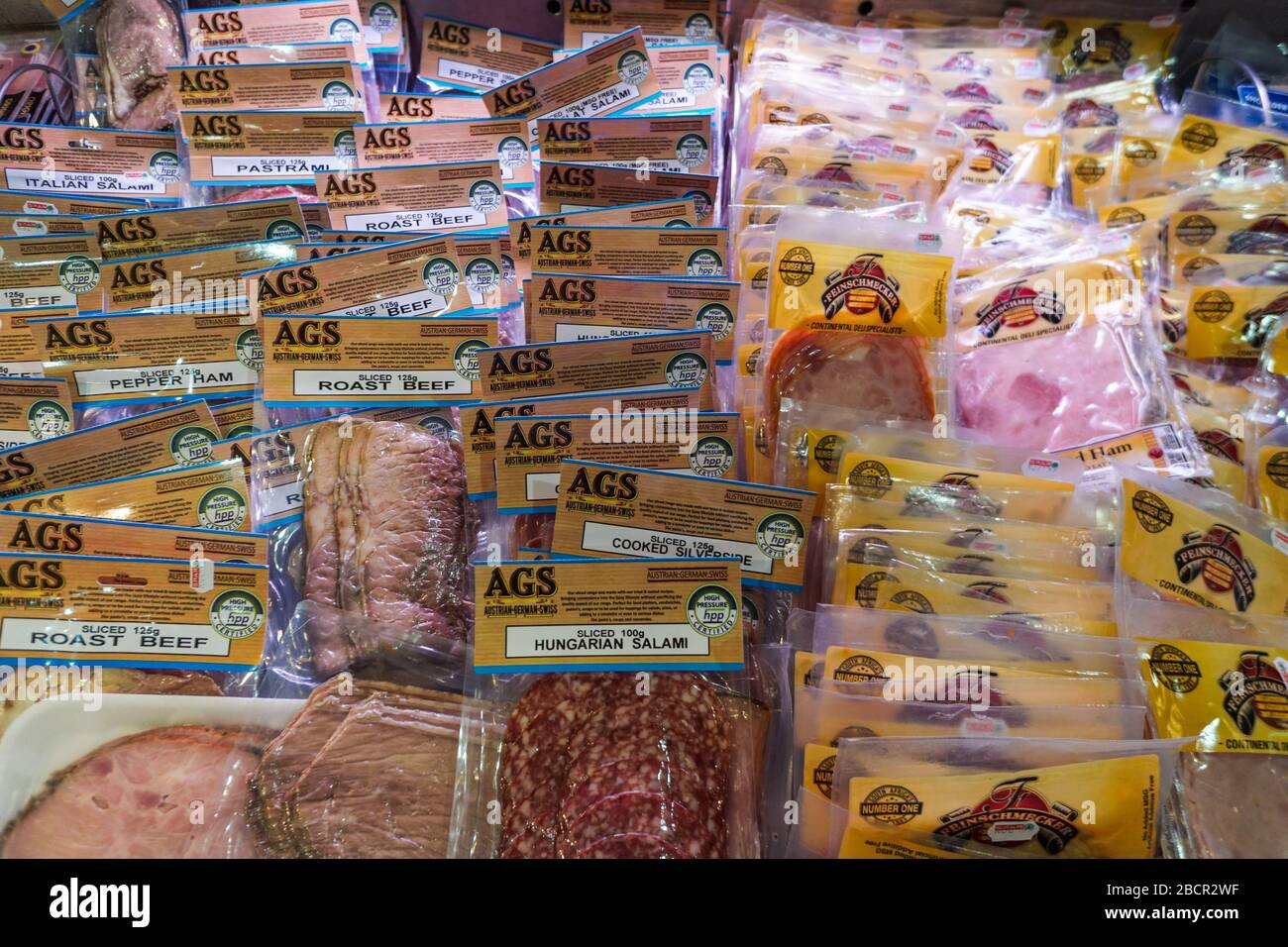 vacuum packed cold meats or cold cuts on display in an open fridge in a supermarket store or shop in South Africa Stock Photo