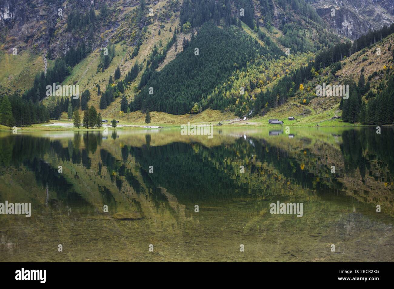 Calm alpine mountain lake in Austria with clear water reflection Stock Photo