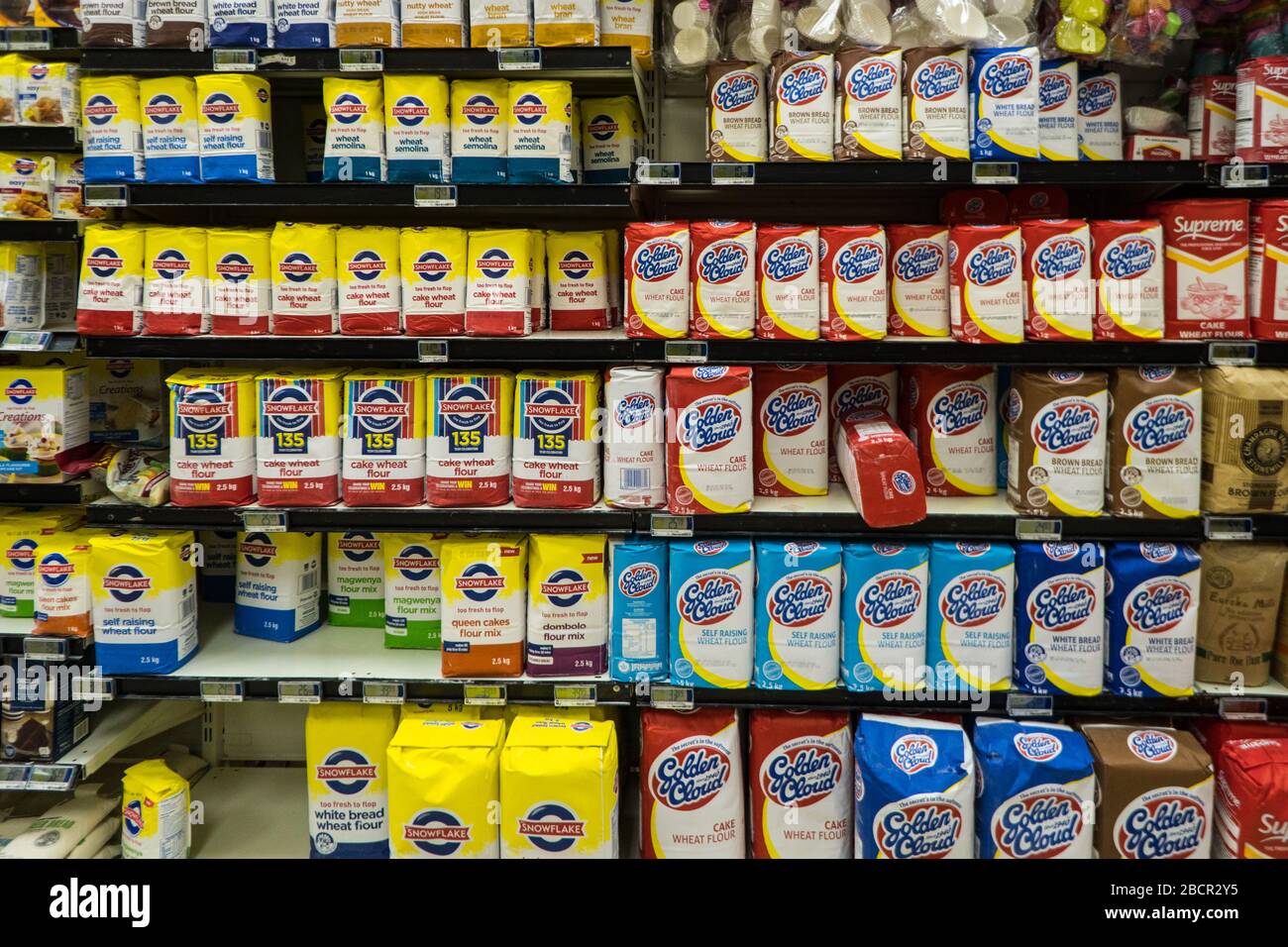 packets or bags of flour on shelves in a baking aisle of a supermarket store or shop in South