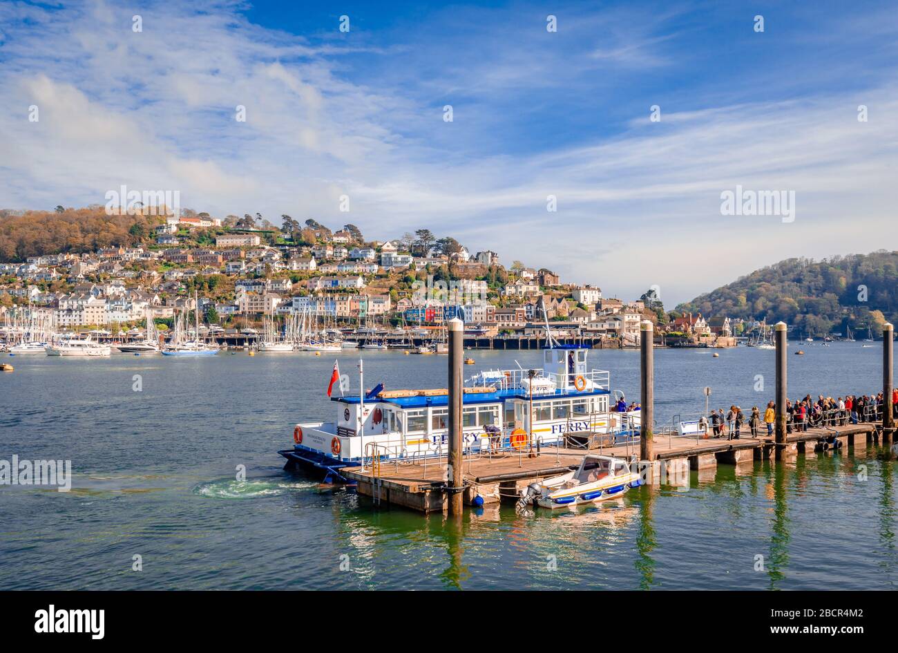 The passengers are ready to embark on the ferry, at the North Embankment terminal in Dartmouth, Devon, England. Kingswear is in the background. Stock Photo