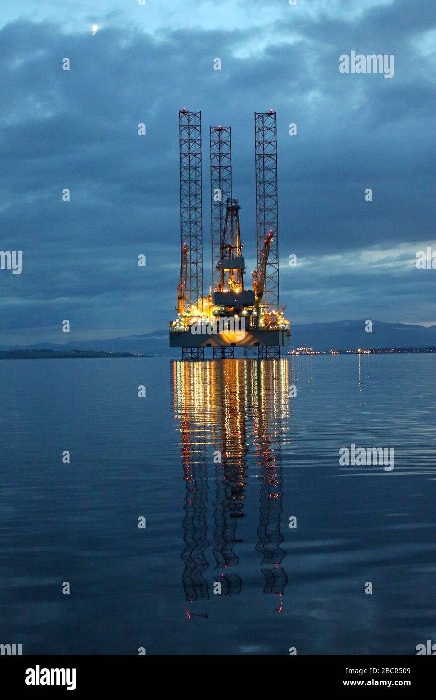 Oil drilling rig after sunset in the moonlight, Moray Firth, North Sea Stock Photo