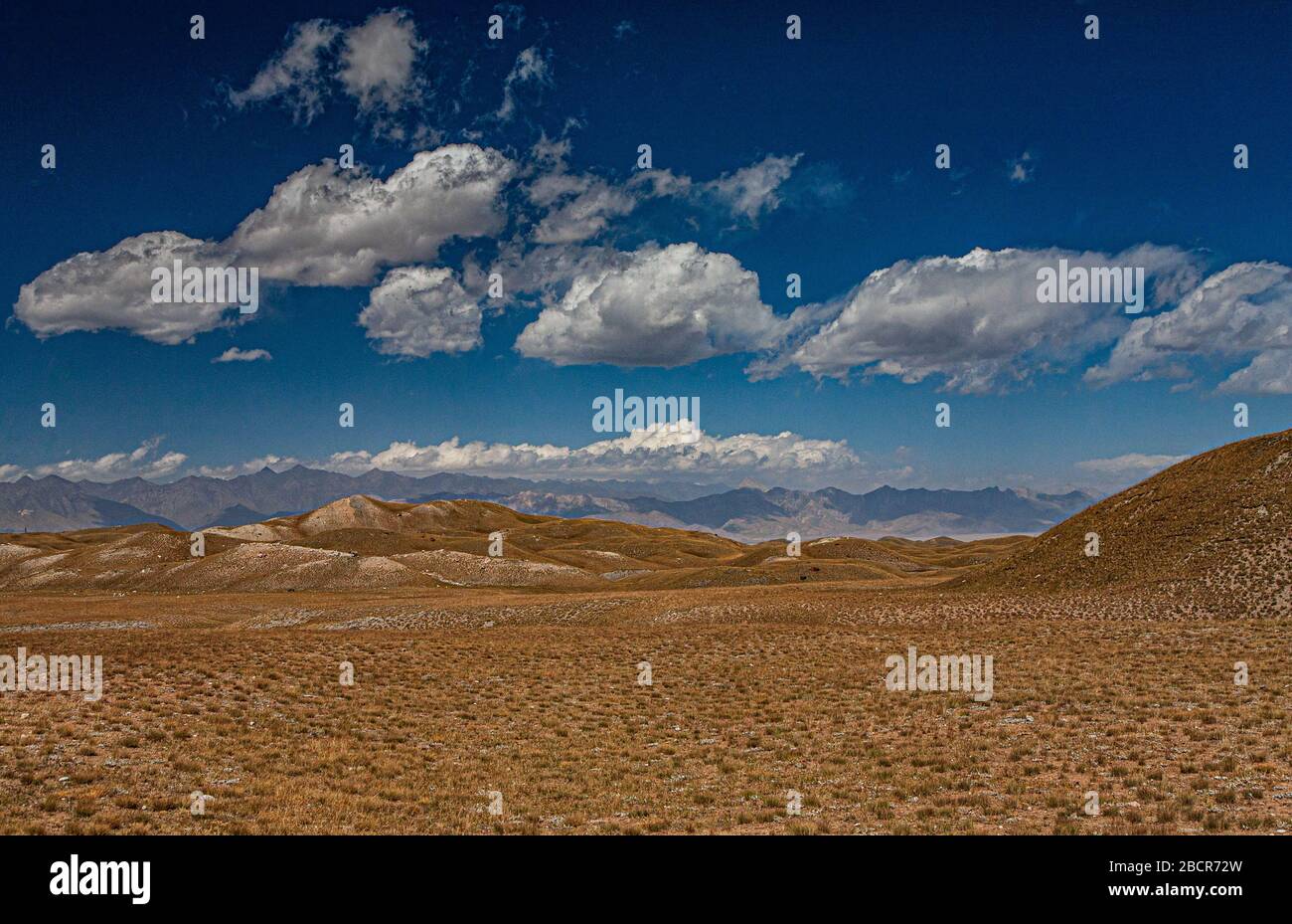 Kyrgyz nature. The Trans-Alay Range. Pamir Mountain System. Cloudy day. Hilly terrain. Stock Photo