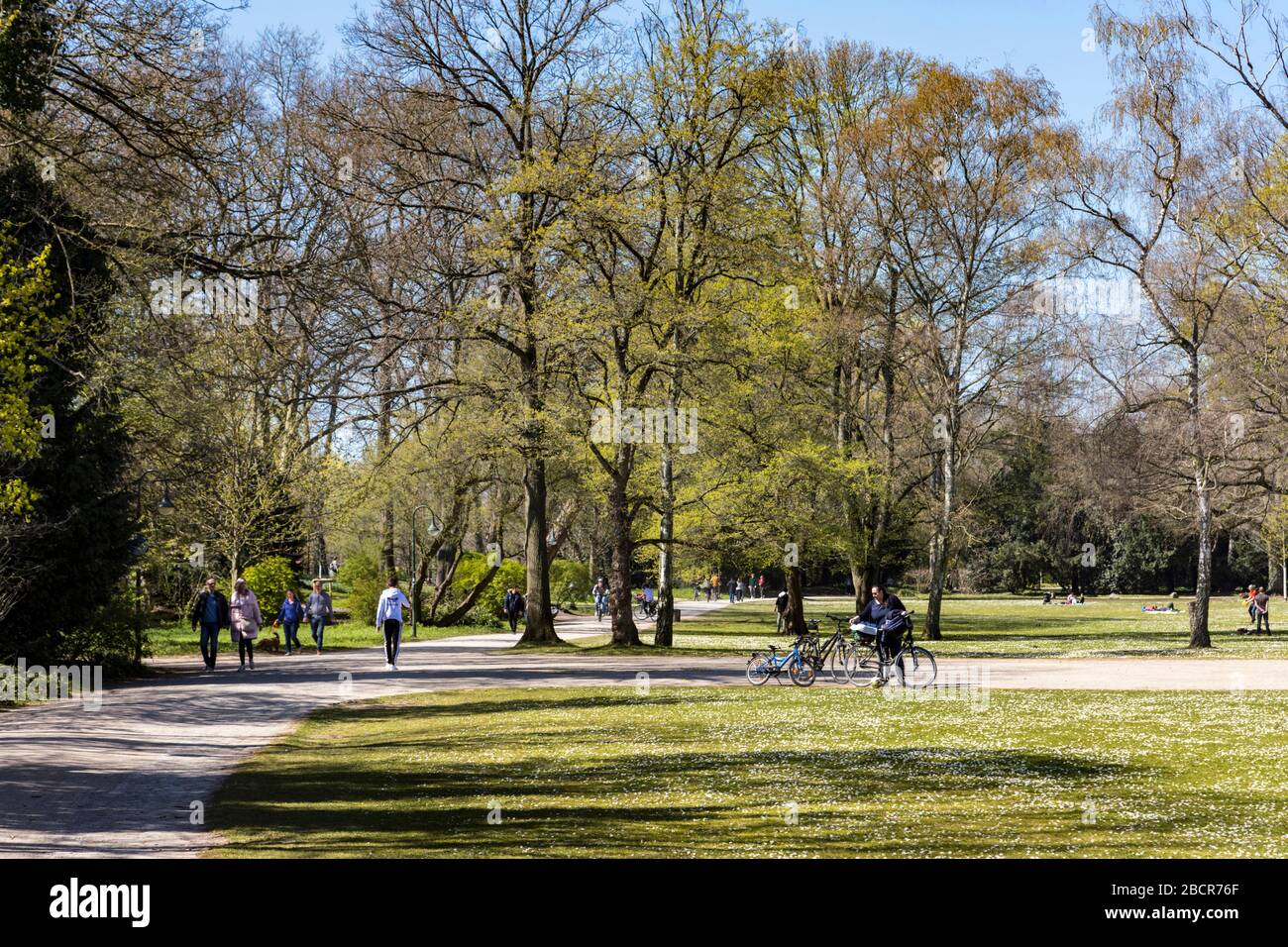 New everyday situation due to coronavirus pandemic. Despite the best spring weather, safety regulations must be observed. Weekend in Sudpark. Stock Photo