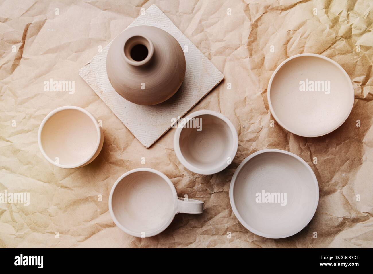 Brown unpainted pots and bowls on craft paper Stock Photo