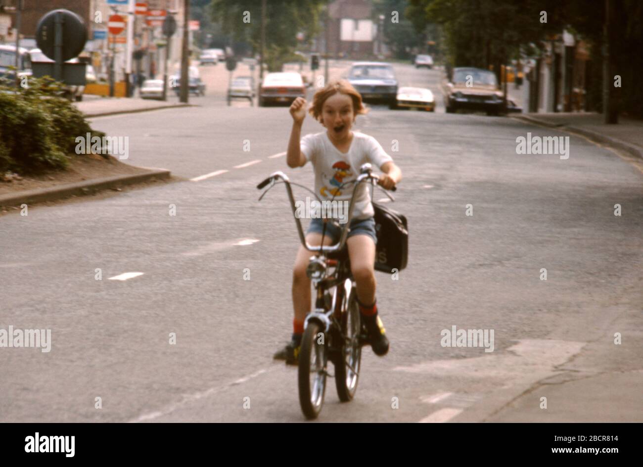 Young boy riding his Raleigh Chopper bike along the road in Hatch End, Middlesex, UK 1974 Stock Photo