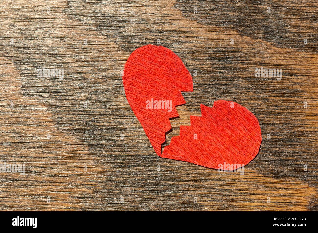 Broken heart on wooden background Stock Photo