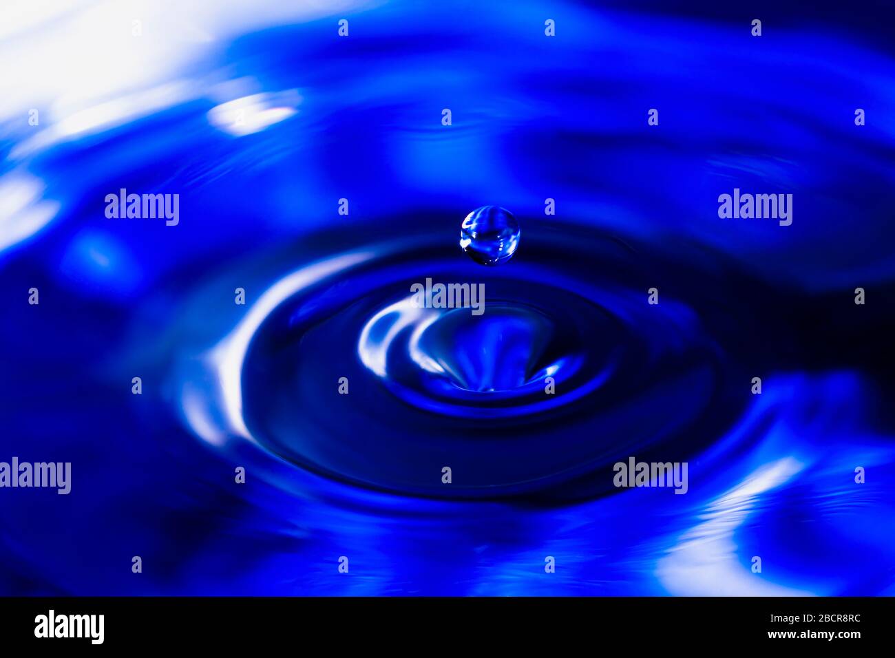 blue water drop falling, water splash background Stock Photo