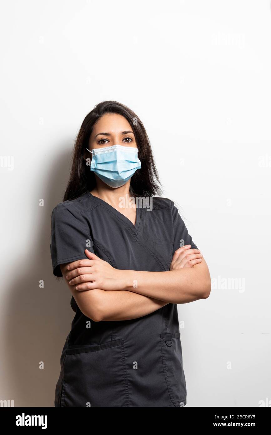 Portrait of a health professional wearing a mask. Dentist, doctor, nurse, assistant, isolated from white background. Stock Photo