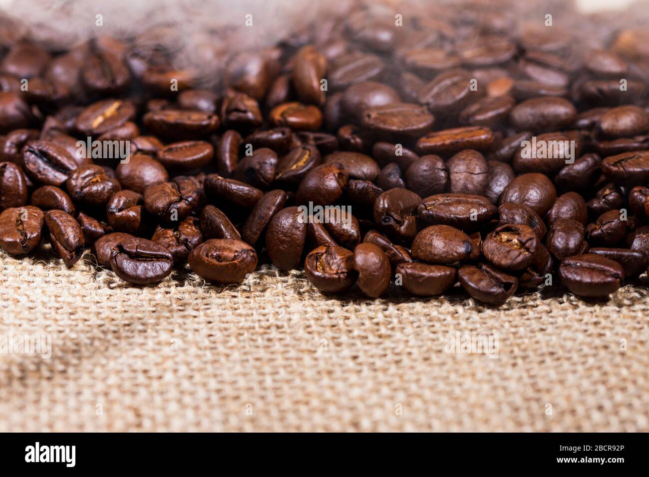 coffee beans on burlap background Stock Photo