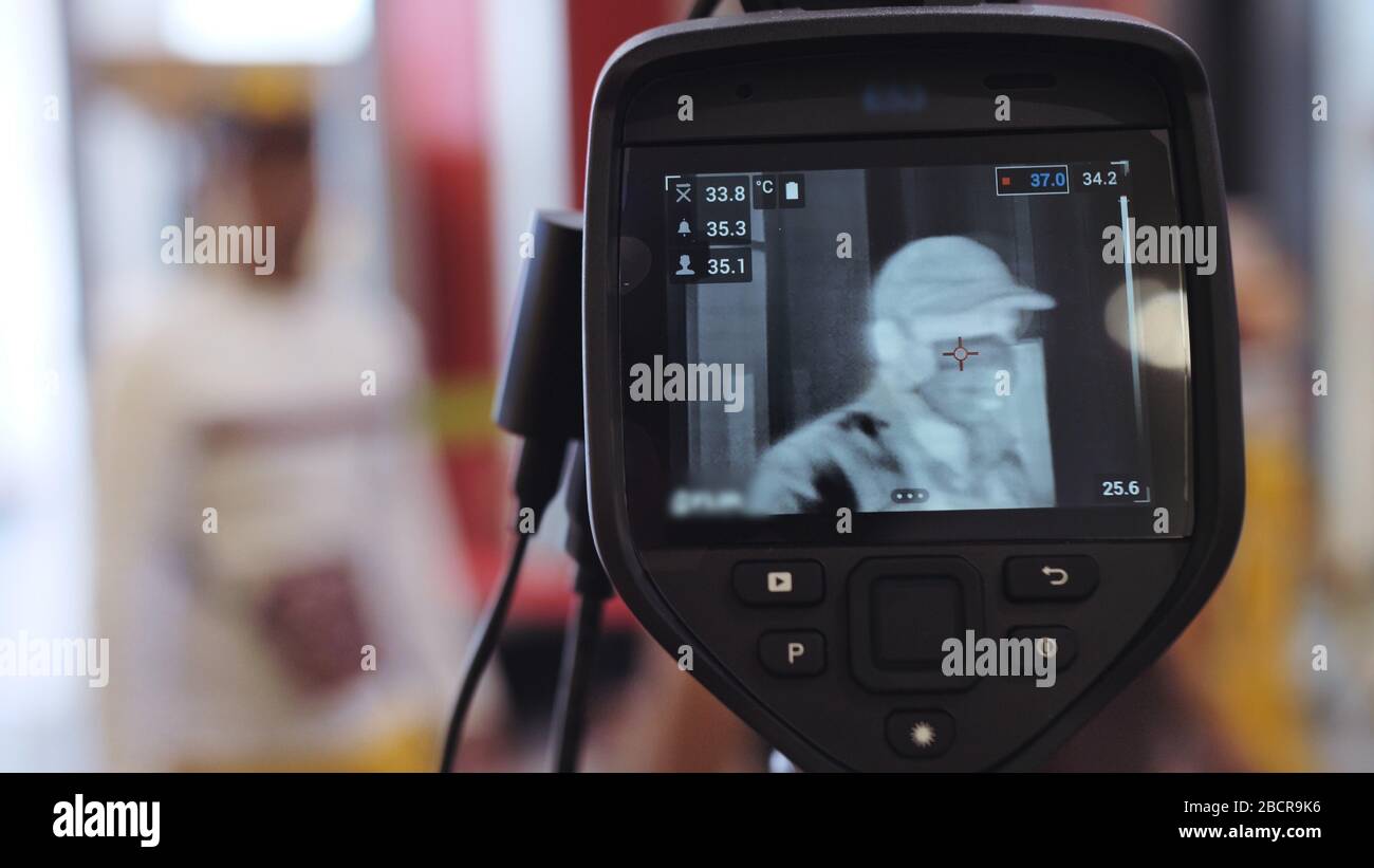 Temperature Check Commercial Temperature check at a supermarket, grocery store with a thermal ...