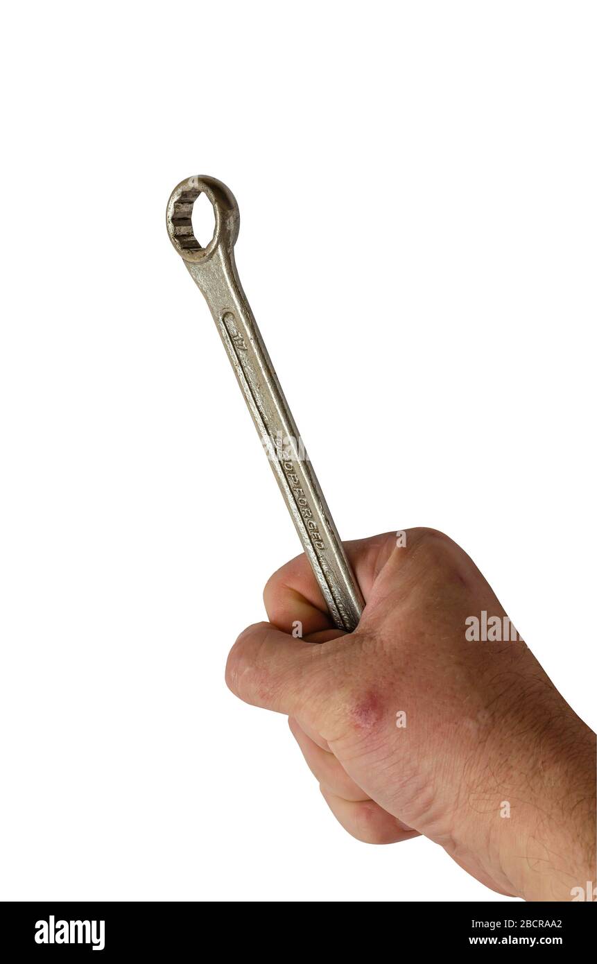 Wrench in the hand. The male hand of an adult male holds an allen key. Isolate on a white background. Close-up. Selective focus. Stock Photo