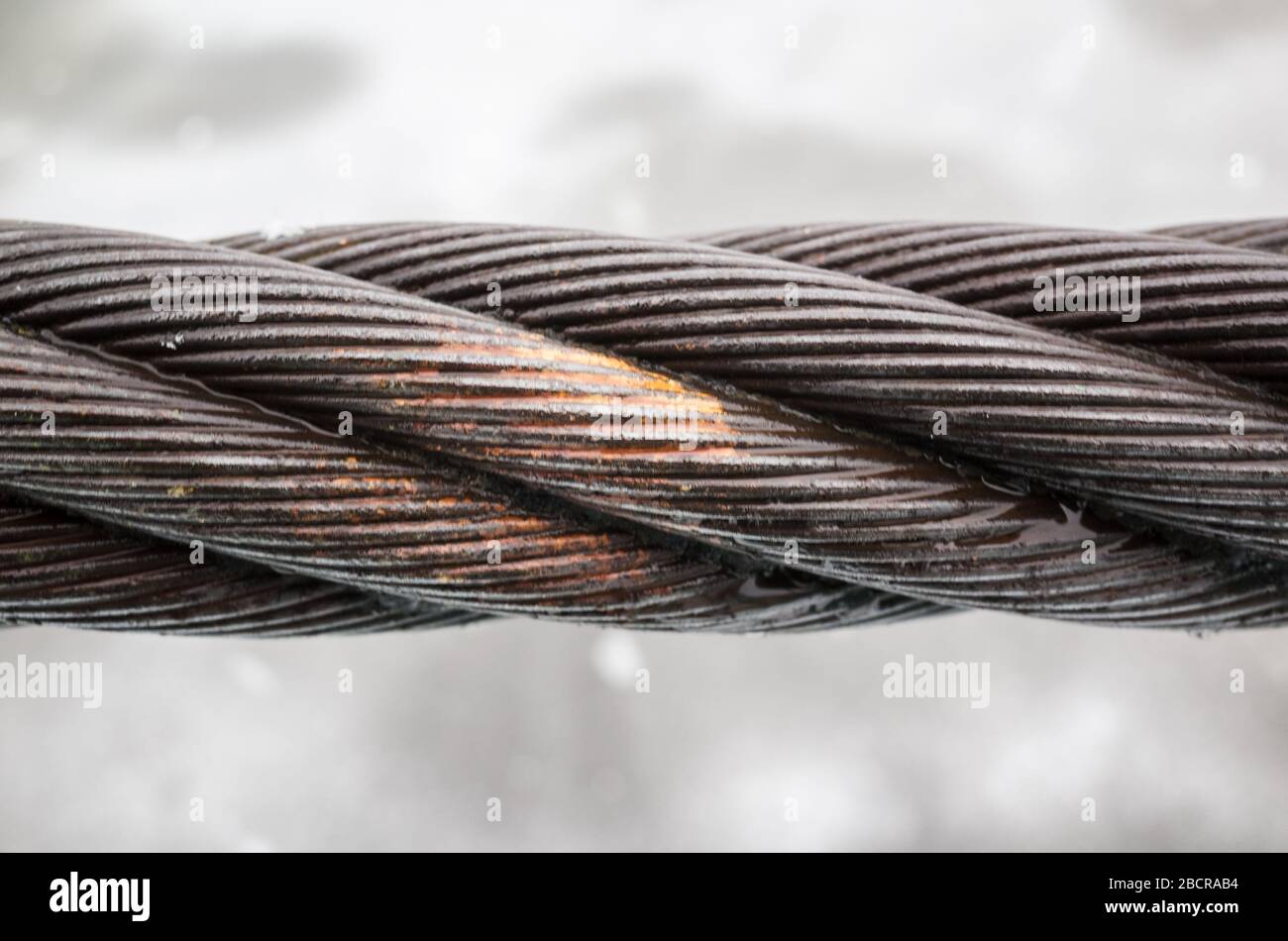 Steel rope with rusty spots, macro photo with selective focus Stock Photo