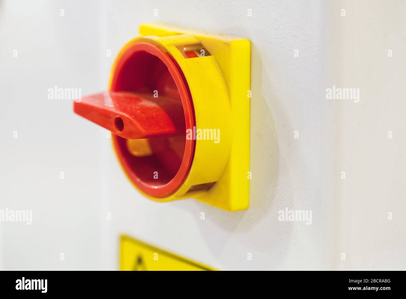 Red round plastic machine switch, close-up photo with selective soft focus Stock Photo