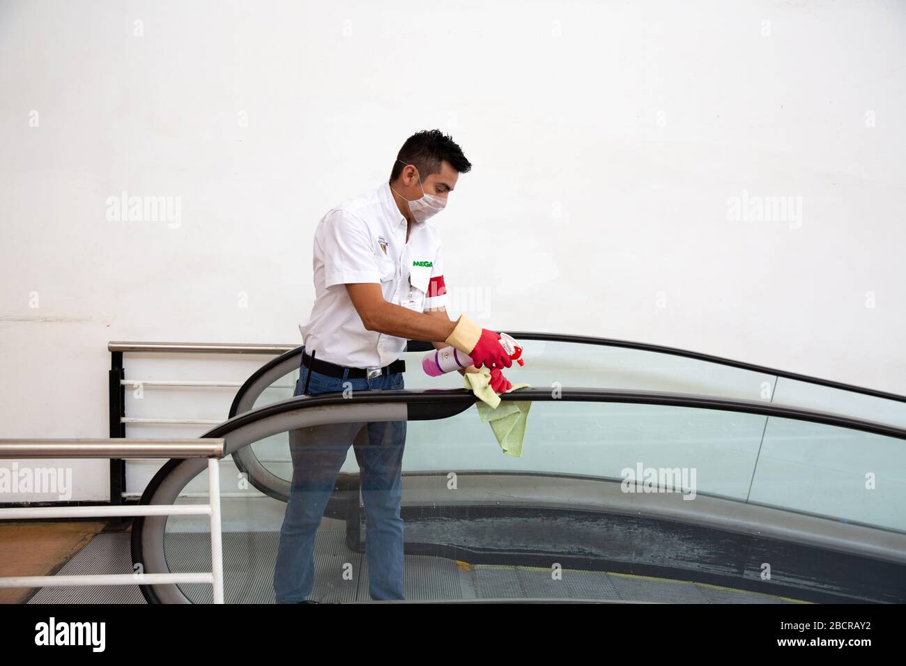 An employee cleans and sanitizes the core of an escalator at the entrance of a supermarket in Merida, Yucatan, Mexico on April 4, 2020. Coronavirus disease (COVID-19) is an infectious disease caused by a newly discovered coronavirus. Most people infected with this virus will experience mild to moderate respiratory illness and recover without requiring special treatment. Older adults and those with underlying medical conditions such as cardiovascular diseases, diabetes, chronic respiratory diseases, compromised immune systems and cancer face increased risk of serious illness or death. The World Stock Photo