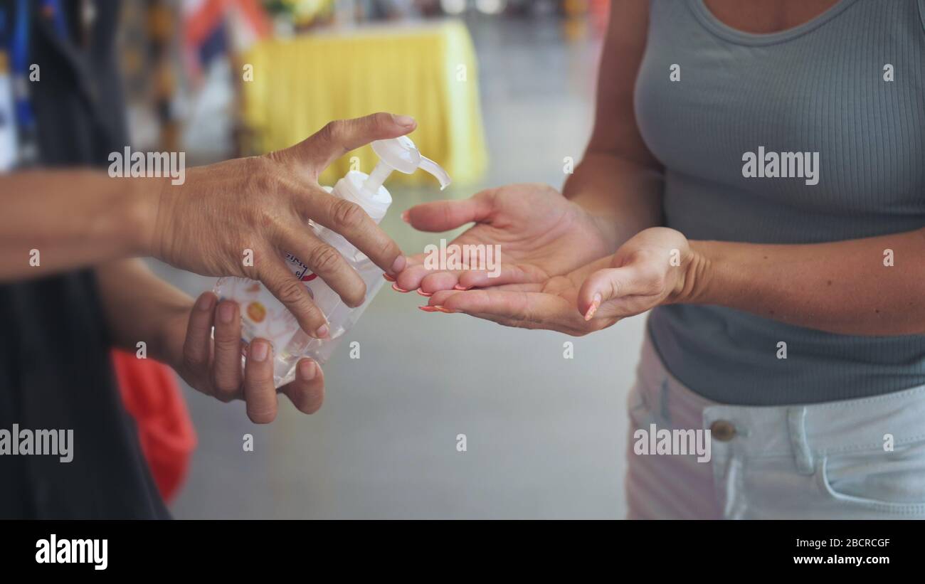 Hand Sanitizer gel. Hand treatment with alcohol. Temperature check at