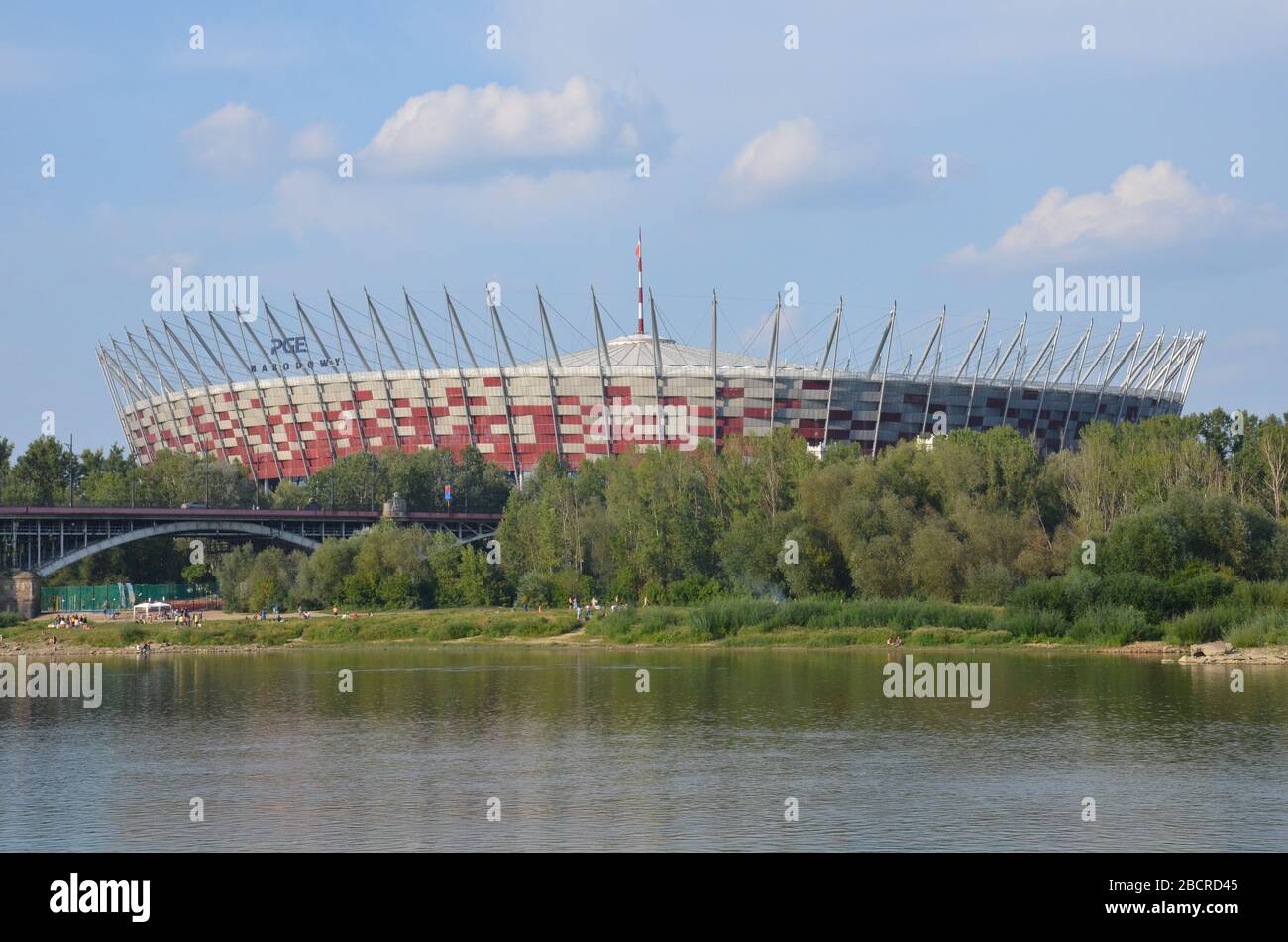 PGE Narodowy (Polish national stadium) in Praga and Poniatowski Bridge, viewed from the West Bank of the Vistula river, August, Warsaw, Poland, 2019 Stock Photo